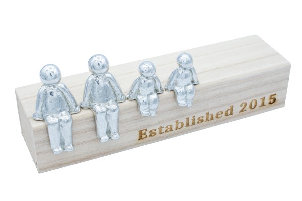 metal figures sat on a wooden box